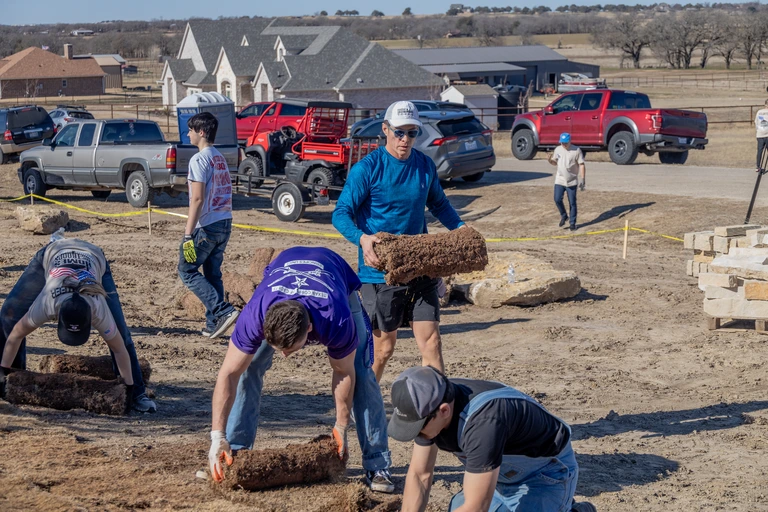 Populus Financial Group laying sod at HFOT build site